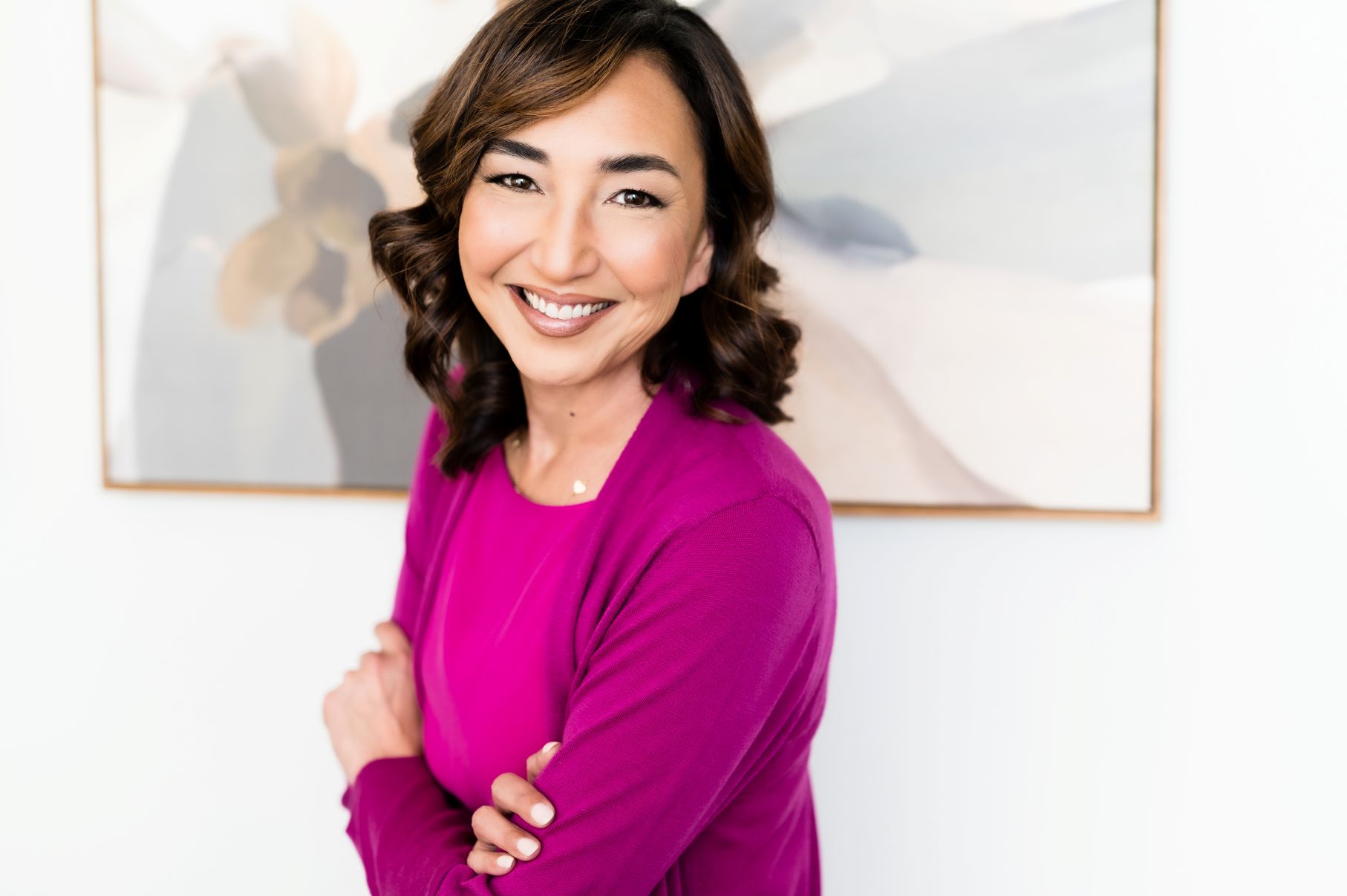 nyl agent diane wearing magenta smiling and leaning forward with arms gently crossed